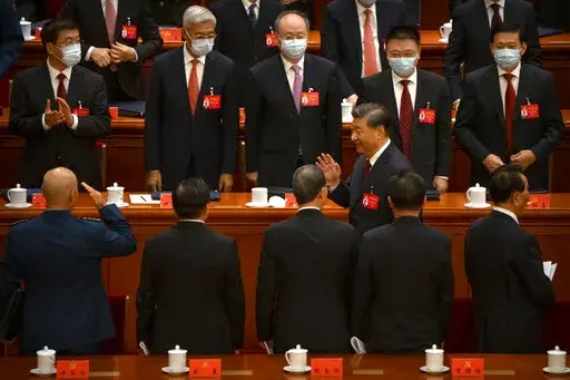 Chinese President Xi Jinping waves as he leaves the opening ceremony of the 20th National Congress of China's ruling Communist Party at the Great Hall of the People in Beijing, Sunday, Oct. 16, 2022.  Xi signaled Sunday that his government would maintain policies that have put it at odds with the U.S. and other nations and deepened Communist Party control of the economy and society. (AP Photo/Mark Schiefelbein)