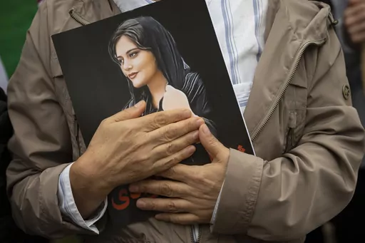 A portrait of Mahsa Amini is held during a rally calling for regime change in Iran following the death of Amini, a young woman who died after being arrested in Tehran by Iran's notorious "morality police," in Washington, on Oct. 1, 2022. Mahsa Amini, the 22-year-old Kurdish-Iranian woman who died in police custody in Iran last year, sparking worldwide protests against the country’s conservative Islamic theocracy, was awarded the European Union’s top human rights prize on Thursday, Oct. 19, 2