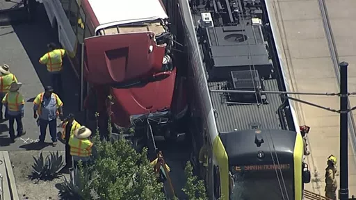 In this aerial still image provided by KABC-TV, firefighters respond to the scene of an accident where a shuttle bus collided with a Metro light rail train on Tuesday, April 30, 2024, in Los Angeles. (KABC via AP)