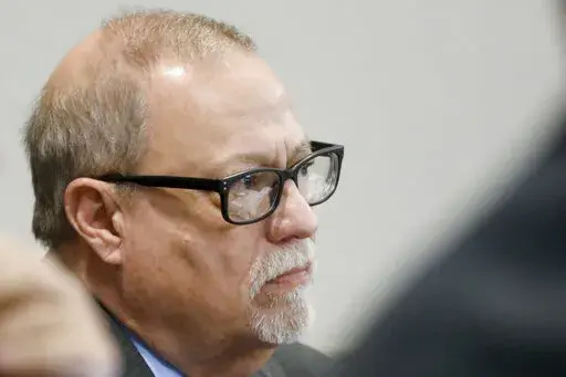 Defendant Gregory McMichael looks on during his trial along with and his son, Travis McMichael, and a neighbor, William "Roddie" Bryan, in the February 2020 slaying of 25-year-old Ahmaud Arbery, on Nov. 19, 2021, at the Glynn County Courthouse in Brunswick, Ga. Greg McMichael won’t plead guilty to a federal hate crime in the 2020 killing of the unarmed Black man, according to a legal filing late Thursday, Feb. 3, 2022. McMichael reversed his plan to plead guilty in the federal case days after 