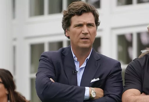 Tucker Carlson attends the final round of the Bedminster Invitational LIV Golf tournament in Bedminster, N.J., Sunday, July 31, 2022. Fox News says it has agreed to part ways with Tucker Carlson, less than a week after settling a lawsuit over the network’s 2020 election reporting. The network said in a press release Monday that the popular and controversial prime-time host's last program aired on Friday. (AP Photo/Seth Wenig, File)