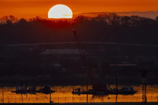 Salvage crews work near the wreckage site in the Potomac River of a mid-air collision between an American Airlines jet and a Black Hawk helicopter, at Ronald Reagan Washington National Airport, Feb. 4, 2025, in Arlington, Va. (AP Photo/Ben Curtis, file)