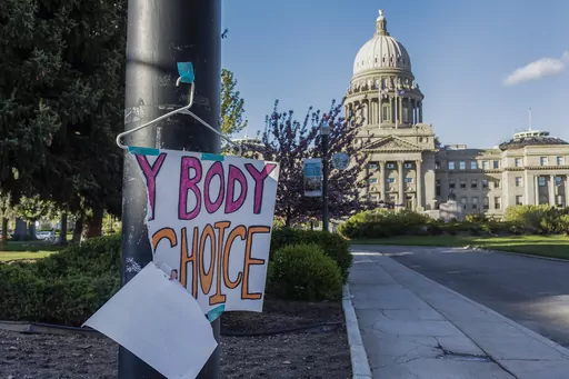 A sign reading "My body, my choice," is taped to a hanger taped to a streetlight in front of the Idaho state Capitol Building in Boise, Idaho, May 3, 2022. Abortion is banned in Idaho at all stages of pregnancy, but the governor on Wednesday, April 5, 2023 signed another law making it illegal to provide help within the state’s boundaries to minors seeking abortion without parental consent. (Sarah A. Miller/Idaho Statesman via AP, File)