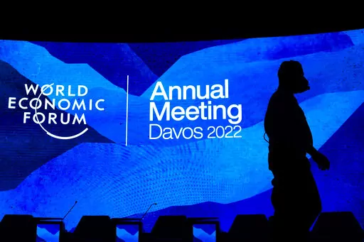 Workers set the stage prior to the annual meeting of the World Economic Forum, in Davos, Switzerland, Sunday, May 22, 2022. The World Economic Forum reported on Wednesday, July 13, 2022, that the cost-of-living crisis, sparked in part by higher fuel and food prices, is expected to hit women the hardest. (Gian Ehrenzeller/Keystone via AP, File)