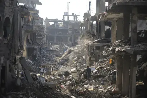 Palestinians inspect their homes destroyed by Israeli attacks in Jebaliya, northern Gaza Strip, Wednesday, Jan. 29, 2025. (AP Photo/Jehad Alshrafi)