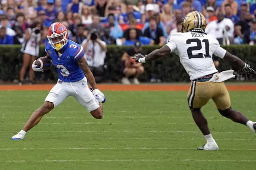 Florida wide receiver Eugene Wilson III (3) looks for a way around Vanderbilt safety Savion Riley (21) after a reception during the first half of an NCAA college football game, Saturday, Oct. 7, 2023, in Gainesville, Fla. (AP Photo/John Raoux)