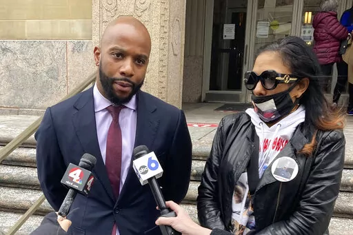Sean Walton, left, an attorney representing the family of Casey Goodson Jr., and Goodson's mother, Tamala Payne, take questions after a hearing to determine whether the former Ohio sheriff's deputy who fatally shot Goodson in 2020 should be tried in state or federal court, on Friday, Feb. 11, 2022, in Columbus, Ohio. Walton said murder cases are almost always tried in state court, and said that's where this prosecution belongs. (AP Photo/Andrew Welsh-Huggins)