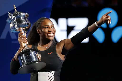 United States' Serena Williams holds her trophy after defeating her sister, Venus, during the women's singles final at the Australian Open tennis championships in Melbourne, Australia, Jan. 28, 2017. Williams famously won the tournament when she was eight weeks pregnant. An expert said mothers often are better athletes because they learn how to manage their time better, they understand their bodies better and they may be peaking even later in life. (AP Photo/Dita Alangkara, File)