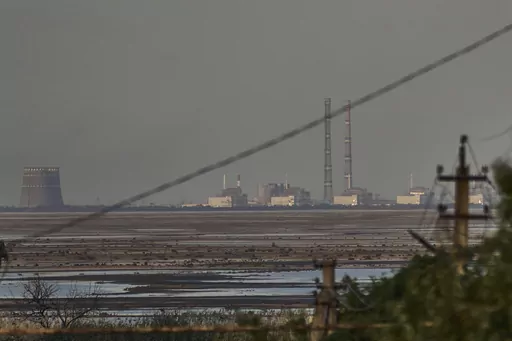The Zaporizhzhia nuclear power plant, Europe's largest, is seen in the background of the shallow Kakhovka Reservoir after the dam collapse, in Energodar, Russian-occupied Ukraine, Tuesday, June 27, 2023. The U.N. atomic watchdog said in a statement late Monday, July 24, 2023, its staff at Ukraine’s Russian-occupied Zaporizhzhia Nuclear Power Plant report seeing anti-personnel mines around the site. The report comes as Kyiv pursues a counteroffensive against the Kremlin’s entrenched forces af