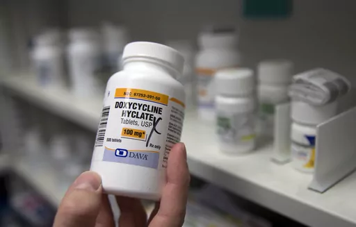 A pharmacist holds a bottle of the antibiotic doxycycline hyclate in Sacramento, Calif., July 8, 2016. On Tuesday, April 11, 2023, the Centers for Disease Control and Prevention released data about some of the most common infectious diseases in the U.S. The numbers show how chlamydia, gonorrhea and syphilis infections have been accelerating across the country. Meanwhile, the CDC is considering recommending the antibiotic doxycycline to be used after sex to prevent those infections. (AP Photo/Ric