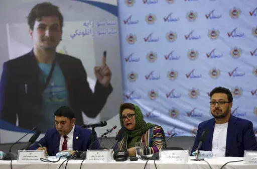 FILE - Hawa Alam Nuristani, chief of Election Commission of Afghanistan, center, speaks during a press conference at the Independent Election Commission office in Kabul, Afghanistan, Feb. 18, 2020. The Taliban dissolved Afghanistan's Independent Election Commission and Electoral Complaint Commission as well as the state ministries for peace and parliamentarian affairs, an official said Sunday, Dec. 26, 2021. (AP Photo/Rahmat Gul, File)