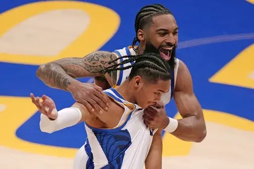 Pittsburgh 's Damian Dunn, rear, celebrates his basket with Jaland Lowe at the end of the first half of an NCAA college basketball game against West Virginia Friday, Nov. 15, 2024, in Pittsburgh. (AP Photo/Gene J. Puskar)