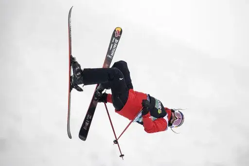 FILE- Eileen Gu, of China, makes a run in the slopestyle finals, Friday, Dec. 17, 2021, during the Dew Tour freestyle skiing event at Copper Mountain, Colo. Gu, who was born and raised in the U.S. by Chinese immigrants, is the hotshot freestyle skier competing for China in the Beijing Olympics. Gu has raised eyebrows for switching to the China team after training with the U.S. team, but the San Francisco native, who speaks fluent Mandarin and makes yearly trips to China with her mom, is clear-ey