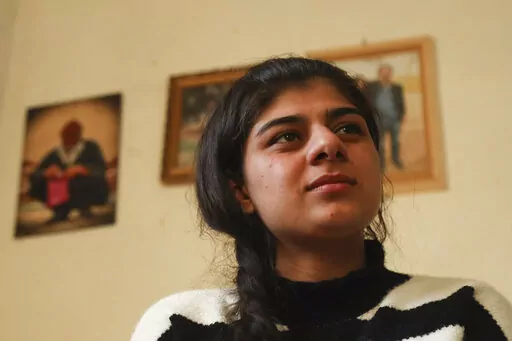 Roza Barakat poses for a portrait in a safe house in Hassakeh, Syria, Sunday, Feb. 6, 2022. Barakat was 11 years old when she was taken by IS militants, along with thousands of others, when the extremists overran her hometown of Sinjar in northwestern Iraq. Eight years later, she is living in the shadows, afraid to go home and fearing her community won't accept her. (AP Photo/Baderkhan Ahmad)