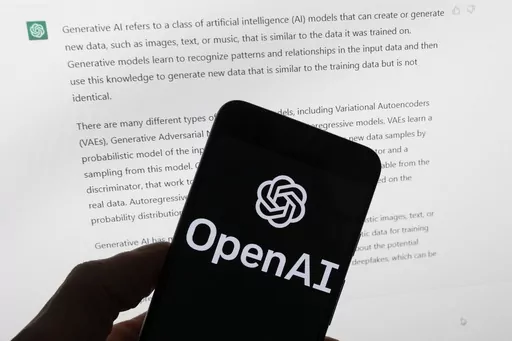 The OpenAI logo is seen on a mobile phone in front of a computer screen displaying output from ChatGPT, on March 21, 2023, in Boston. The Italian government’s privacy watchdog said Friday March 31, 2023 that it is temporarily blocking the artificial intelligence software ChatGPT in the wake of a data breach. (AP Photo/Michael Dwyer, File)
