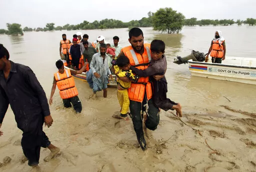 Army troops evacuate people from a flood-hit area in Rajanpur, district of Punjab, Pakistan, Aug. 27, 2022. Loss and damage is the human side of a contentious issue that will likely dominate climate negotiations in Egypt. Extreme weather is worsening as the world warms, with a study calculating that human-caused climate change increased Pakistan’s flood-causing rain by up to 50%. (AP Photo/Asim Tanveer, File)