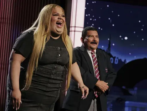 This image released by Disney shows TikTok creator Jools Lebron, left, with talk show personality Guillermo Rodriguez on the set of "Jimmy Kimmel Live!," Aug. 19, 2024, in Los Angeles. (Randy Holmes/ABC-Disney via AP, File)