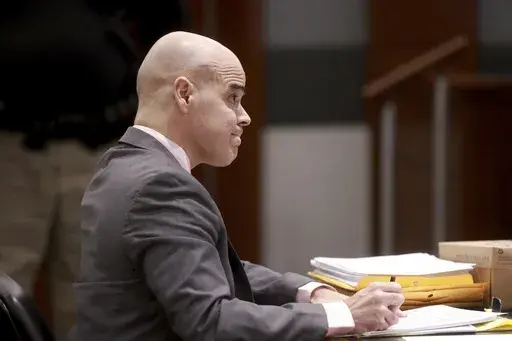 Robert Telles, a former Clark County public administrator charged in the murder of Las Vegas Review-Journal investigative journalist Jeff German, takes notes while listening to testimony during his murder trial at the Regional Justice Center in Las Vegas, Friday, Aug. 16, 2024. (K.M. Cannon/Las Vegas Review-Journal via AP, Pool)