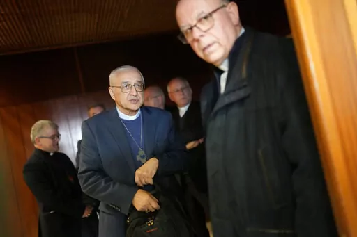 The head of the Portuguese Bishops Conference, Bishop Jose Ornelas, centre, arrives for a news conference to comment on the report released hours earlier by the Independent Committee for the Study of Child Abuse in the Catholic Church, set up by Portuguese bishops, in Lisbon, Monday, Feb. 13, 2023. The Committee says 512 alleged victims have come forward, but their report warned that the true number is likely higher than 4,800. (AP Photo/Armando Franca)