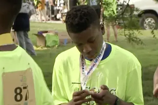 Ralph Yarl looks at a badge that he received after walking at a brain injury awareness event, May 29, 2023, in Kansas City, Mo. (KCTV via AP, File)