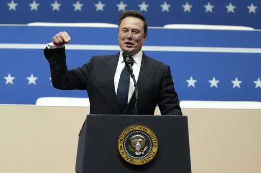 Elon Musk speaks at an indoor Presidential Inauguration parade event in Washington, Monday, Jan. 20, 2025. (AP Photo/Matt Rourke)