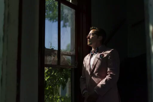 Scout, a transgender man who uses one name, stands in the entrance to his home in Providence, R.I., Wednesday, June 8, 2022. The 2020 census questionnaire drove Scout crazy. With no direct questions about sexual orientation and gender identity, it made him feel invisible, not worth including in the U.S. head count. (AP Photo/David Goldman)