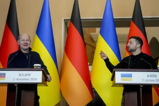 Ukraine's President Volodymyr Zelenskyy, right, and German Chancellor Olaf Scholz attend a press conference in Kyiv, Ukraine, Monday, Dec.2, 2024. (AP Photo/Evgeniy Maloletka)