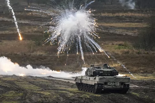 A Leopard 2 tank is seen in action at the Bundeswehr tank battalion 203 at the Field Marshal Rommel Barracks in Augustdorf, Germany, Wednesday, Feb. 1, 2023. Germany’s defense industry says it stands ready to supply Ukraine with much-needed arms and ammunition, but needs clarity about what the country requires before investing in further production capacity. (AP Photo/Martin Meissner, File )