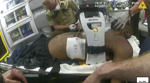 This image from police body camera video shows emergency personal tending to George Floyd after he had been loaded into an ambulance on May 25, 2020, in Minneapolis. A paramedic who treated Floyd on the day he was killed testified Wednesday, Jan. 26, 2022 at the federal civil rights trial of three former Minneapolis police officers that he wasn't told Floyd wasn't breathing and had no pulse when officers upgraded the urgency of an ambulance call. (Minneapolis Police Department via AP, File)