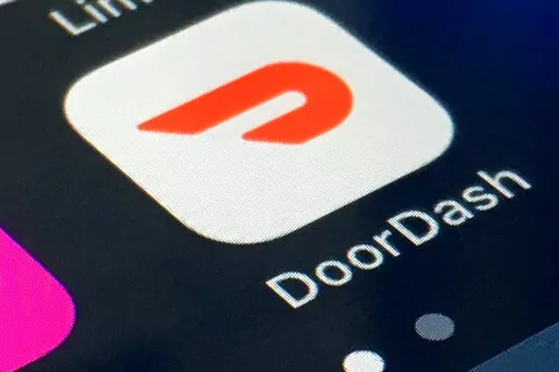 The DoorDash app is shown on a smartphone on Feb. 27, 2020, in New York. Delivery company DoorDash said Tuesday, March 15, 2022, it will refund its drivers for some U.S. gasoline purchases to help offset higher prices at the pump. (AP Photo/File)