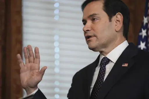 Secretary of State Marco Rubio is sworn by Vice President JD Vance in the Vice Presidential Ceremonial Office in the Eisenhower Executive Office Building on the White House campus, Tuesday, Jan. 21, 2025, in Washington. (AP Photo/Evan Vucci)