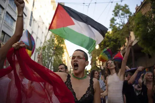 FILE — Protesters shout slogans against Israel's military operation in Gaza Strip during the annual Pride parade, in Athens, Greece, June 15, 2024. At Pride events across the U.S, internal tensions over the ongoing war between Israel and Hamas in Gaza have seeped into the festivities, spurring boycotts and demonstrations at marches and exposing divisions within a movement firmly rooted in protest. (AP Photo/Michael Varaklas, File)
