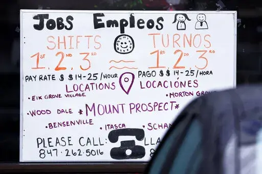 A hiring sign is displayed at a job agency in Mount Prospect, Ill., Thursday, Jan. 3, 2023. An economic downturn remains very possible. Yet in recent weeks, with inflation showing widespread signs of easing, a more cheerful view has begun to gain traction: Maybe a recession isn't inevitable after all.(AP Photo/Nam Y. Huh, File)