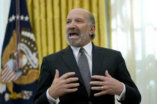 Commerce Secretary nominee Howard Lutnick speaks in the Oval Office of the White House after President Donald Trump signed an executive order, Thursday, Feb. 13, 2025, in Washington. (AP Photo/Ben Curtis)