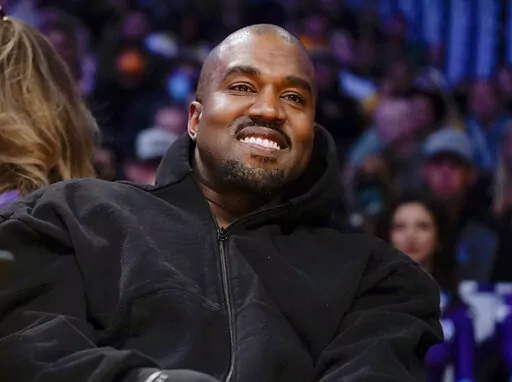 Kanye West watches the first half of an NBA basketball game between the Washington Wizards and the Los Angeles Lakers in Los Angeles, on March 11, 2022 Adidas has ended its partnership with the rapper formerly known as Kanye West over his offensive and antisemitic remarks. (AP Photo/Ashley Landis, File)