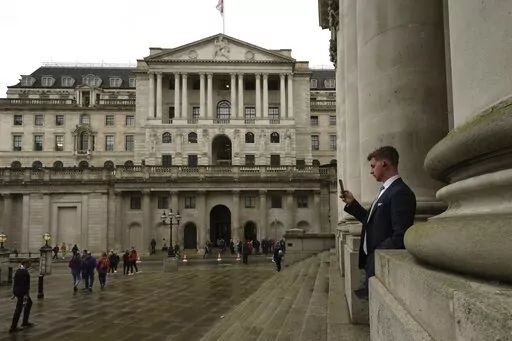 A man walks in front of the Bank of England, at the financial district in London, on Nov. 3, 2022. The Bank of England is expected to raise interest rates by as much as half a percentage point Thursday, Feb. 2, 2023 as it seeks to tame the double-digit inflation fuelling a cost-of-living crisis, public-sector strikes and fears of recession. (AP Photo/Kin Cheung, File)