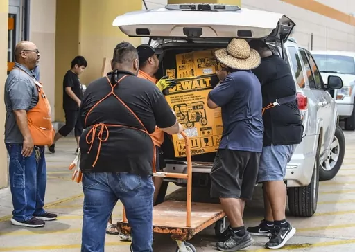 Residents prepare for Typhoon Mawar's approach Monday, May 22, 2023, in Tamuning, Guam. Guam's governor is urging residents to stay home and is warning the island could take a direct hit from Typhoon Mawar. The storm is strengthening on its path toward the U.S. territory in the Pacific. (Rick Cruz/The Pacific Daily via AP)