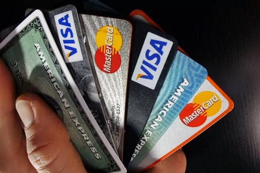 In this March 5, 2012, file photo, consumer credit cards are posed in North Andover, Mass. Consumers' budgets aren't the only avenue to free up money as prices continue to rise due to inflation. The credit cards in consumers' wallets may be packing some valuable perks and potential breathing room to cover large purchases.  (AP Photo/Elise Amendola, File)