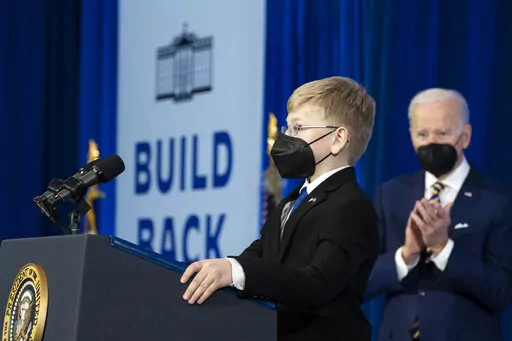 Joshua Davis, 12, introduces President Joe Biden to speak about prescription drug costs at the Daniel Technology Center of Germanna Community College – Culpeper Campus, Thursday, Feb. 10, 2022, in Culpeper, Va. (AP Photo/Alex Brandon)