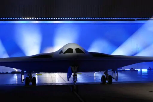 The B-21 Raider stealth bomber is unveiled at Northrop Grumman Friday, Dec. 2, 2022, in Palmdale, Calif. America’s newest nuclear stealth bomber made its debut Friday after years of secret development and as part of the Pentagon’s answer to rising concerns over a future conflict with China. The B-21 Raider is the first new American bomber aircraft in more than 30 years. Almost every aspect of the program is classified. (AP Photo/Marcio Jose Sanchez)