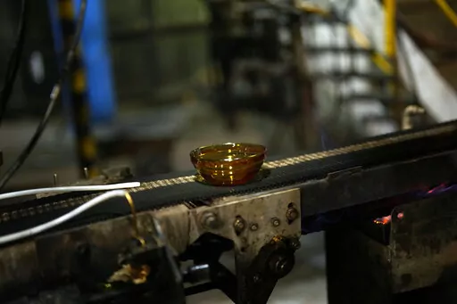 A bowl is manufactured in the factory of the French glassmaker Duralex, in La Chapelle Saint-Mesmin, central France, Wednesday, Sept. 7, 2022. Iconic French tableware brand Duralex is joining a growing array of European firms that are reducing and halting production because of soaring energy costs. (AP Photo/Thibault Camus)