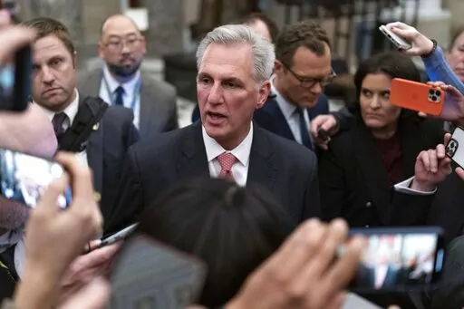 Rep. Kevin McCarthy, R-Calif., talks to reporters as he leaves the House floor after the House voted to adjourn for the evening as the House met for a third day to try and elect a speaker and convene the 118th Congress on Capitol Hill in Washington, Thursday, Jan. 5, 2023. (AP Photo/Jose Luis Magana)