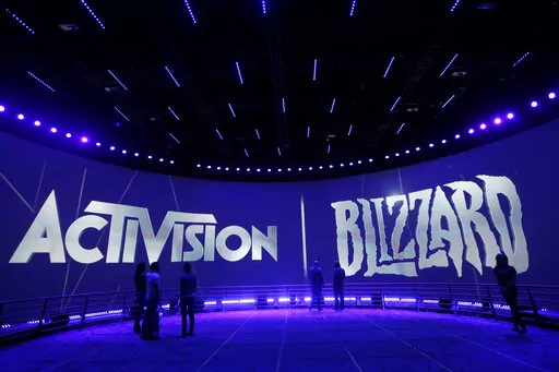 The Activision Blizzard Booth is shown on June 13, 2013 the during the Electronic Entertainment Expo in Los Angeles. Microsoft is buying Activision Blizzard, Tuesday, Jan. 18, 2022,  for $68.7 billion to gain access to blockbuster games including Call of Duty and Candy Crush. The all-cash deal will let Microsoft accelerate mobile gaming and provide it building blocks for the metaverse, or a virtual environment.  (AP Photo/Jae C. Hong, File)