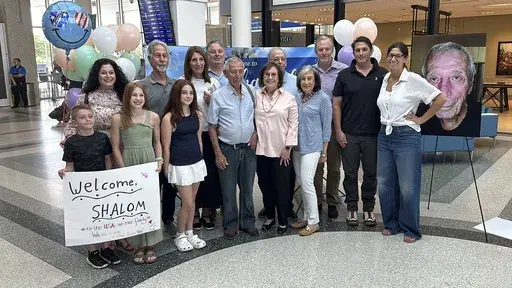 CORRECTS SPELLING TO KORAI NOT KORAY Shalom Korai poses for a picture with members of his extended family just after he met them in person for the first time on Wednesday, July 10, 2024, in North Charleston, S.C. Korai was orphaned during the Holocaust and never knew any of his relatives until a DNA test in 2023. (AP Photo/Jeffrey Collins)