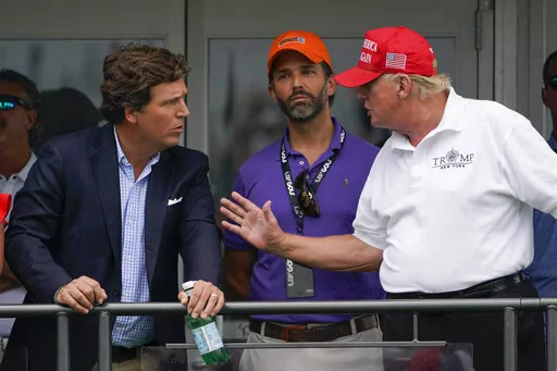 Former President Donald Trump, right, talks with Donald Trump Jr., center, and Tucker Carlson at the 16th tee during the final round of the Bedminster Invitational LIV Golf tournament in Bedminster, N.J., July 31, 2022. Thousands of hours surveillance footage from the Jan. 6, 2021 Capitol attack are being made available to Fox News’ Tucker Carlson. It's a stunning level of access granted by Speaker Kevin McCarthy that is raising new questions about the House Republican leader’s commitment to