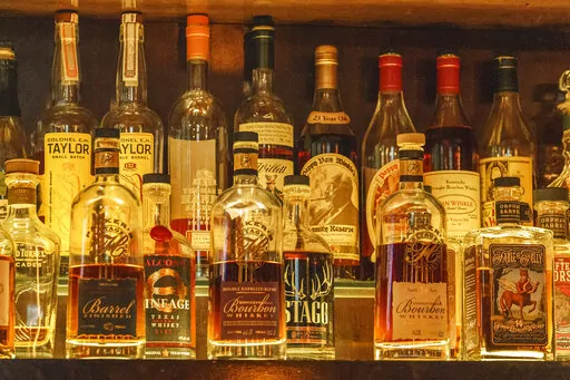 A collection of bottles of Pappy Van Winkle bourbons are seen on the top shelf right, among other fine whiskies at the "Far Bar," located in the historic Far East Building in the heart of Little Tokyo in Los Angeles on Saturday, March 4, 2023. Buttery, smooth, oaky. These are characteristics of the best bourbons, and a growing cult of aficionados is willing to pay an astonishing amount of money for these increasingly scarce premium spirits — and even bend or break laws. (AP Photo/Damian Dovarg