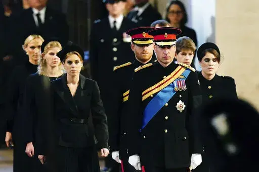 Left to right: Zara Tindall, Lady Louise, Princess Beatrice, Prince William, the prince of Wales, Prince Harry, Princess Eugenie, Viscount James Severn and Peter Phillips attend the vigil of the Queen's grandchildren around the coffin, as it lies in state on the catafalque in Westminster Hall, at the Palace of Westminster, London, Saturday,  Sept. 17, 2022, ahead of her funeral on Monday. (Aaron Chown/Pool Photo via AP)