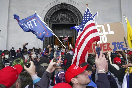 Rioters try to enter the U.S. Capitol on Jan. 6, 2021, in Washington. (AP Photo/John Minchillo)