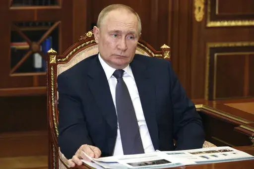 Russian President Vladimir Putin attends a meeting with Moscow Region Governor Andrei Vorobyov at the Kremlin in Moscow, Russia, Monday, July 11, 2022. (Mikhail Klimentyev, Sputnik, Kremlin Pool Photo via AP)