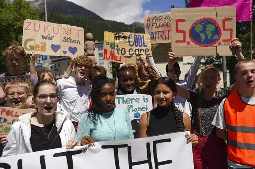 Climate activists Elizabeth Wathuti of Kenia, Vanessa Nakate of Uganda and Helena Gualinga of Ecuador attend the climate protest alongside the World Economic Forum in Davos, Switzerland, May 26, 2022. A group of top climate scientists say the world needs to think about the ultimate climate catastrophe, human extinction, and how possible it is. They are calling on the world's main climate science body to look at the ultimate climate catastrophes, no matter how remotely unlikely they are. (AP Phot